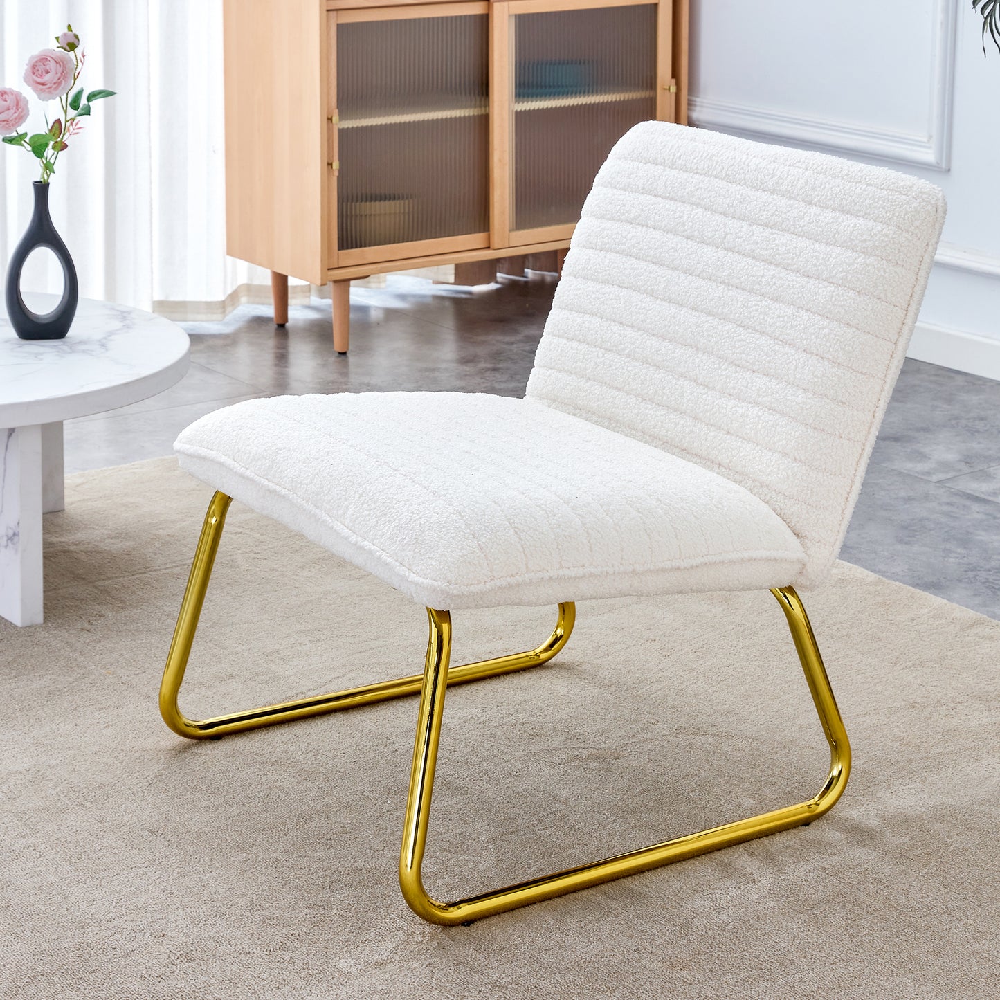 One White minimalist armless sofa chair with plush cushion and backrest paired with golden metal legs, suitable for offices, restaurants, kitchens, bedrooms